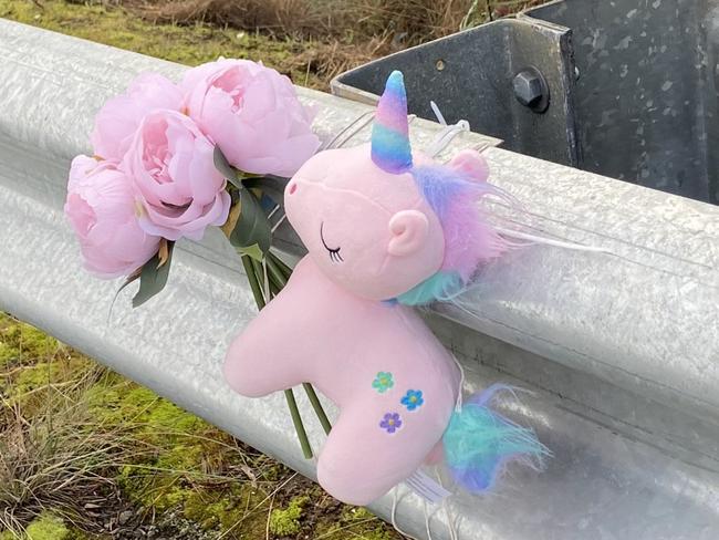 Floral tributes and a small toy unicorn lay at the fatal crash site on Algona Road, where a Huntingfield father and his young daughter were killed in a car crash. Photo: Phil Young