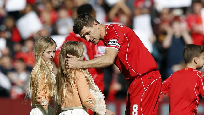 Gerrard greets his daughters as they join him on the pitch ahead of the game.