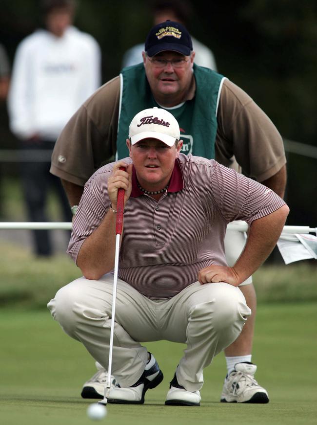 Jarrod Lyle with his caddie and father John Lyle go to work on a putt during the 2005 Heineken Classic at Royal Melbourne.