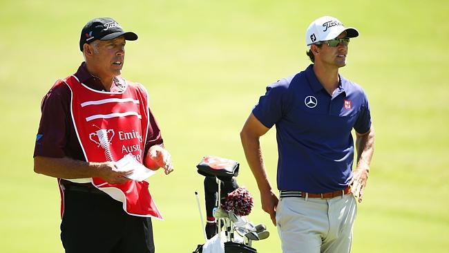 Adam Scott of Australia talks to his caddie Steve Williams.