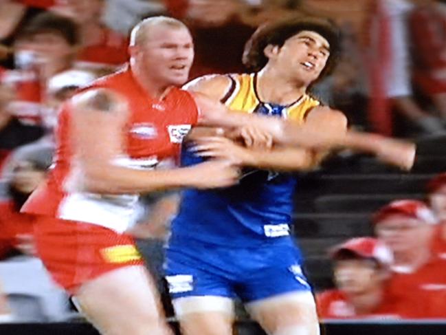 Barry Hall knocks out Eagles player Brent Staker in an off the ball incident at ANZ Stadium in Sydney. PICTURE COURTESY NETWORK 10 .