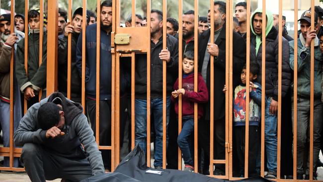 People mourn on Saturday as they collect the bodies of Palestinians killed in an air strike in Khan Younis, Gaza. Picture: Ahmad Hasaballah/Getty Images