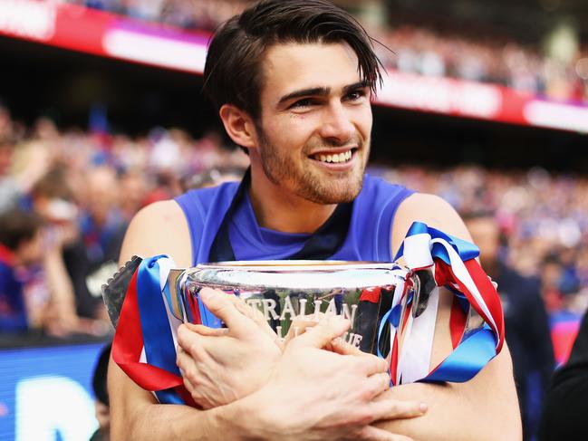 MELBOURNE, AUSTRALIA - OCTOBER 01: Easton Wood of the Bulldogs celebrates with the Premiership Cup after the 2016 Toyota AFL Grand Final match between the Sydney Swans and the Western Bulldogs at the Melbourne Cricket Ground on October 01, 2016 in Melbourne, Australia. (Photo by Ryan Pierse/AFL Media/Getty Images)