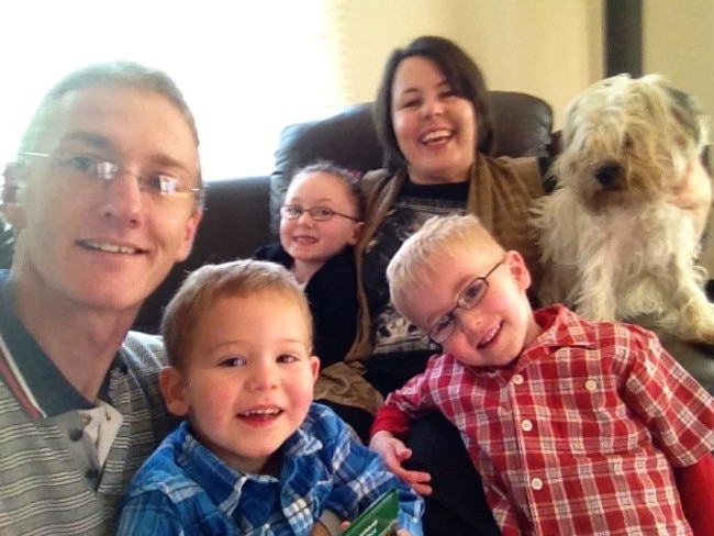 The Davies family at home with their dog.