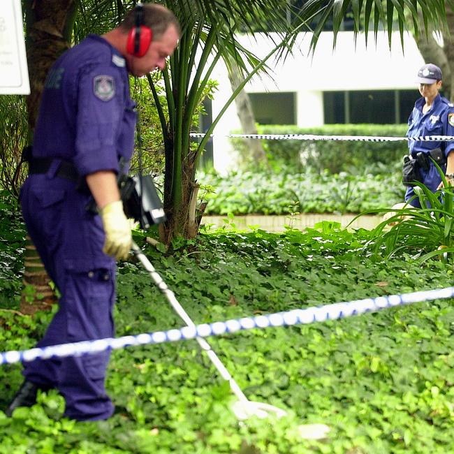Police comb the scene of a shooting in Cavill Avenue
