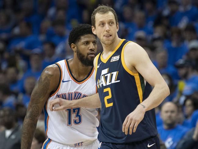 OKLAHOMA CITY, OK - APRIL 15: Joe Ingles #2 of the Utah Jazz defends against Paul George #13 of the Oklahoma City Thunder during the second half of Game 1 of the NBA Western Conference playoffs at the Chesapeake Energy Arena on April 15, 2018 in Oklahoma City, Oklahoma. NOTE TO USER: User expressly acknowledges and agrees that, by downloading and or using this photograph, User is consenting to the terms and conditions of the Getty Images License Agreement.   J Pat Carter/Getty Images/AFP == FOR NEWSPAPERS, INTERNET, TELCOS & TELEVISION USE ONLY ==