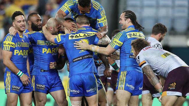 The Eels celebrate a try against the Broncos.