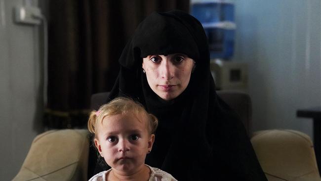 Mariam Dabboussy with her daughter, who was born in Syria, pictured in the administration building of the al-Hawl camp. Picture: ABC