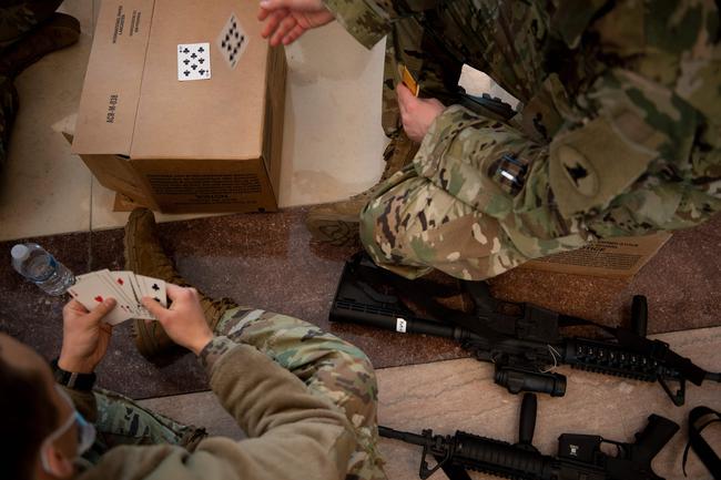 Members of the National Guard rest in the Capitol Visitors Center on Capitol Hill in Washington, DC, January 13, 2021, ahead of an expected House vote impeaching US President Donald Trump. - The Democrat-controlled US House of Representatives on Wednesday opened debate on a historic second impeachment of President Donald Trump over his supporters' attack of the Capitol that left five dead.Lawmakers in the lower chamber are expected to vote for impeachment around 3:00 pm (2000 GMT) -- marking the formal opening of proceedings against Trump. (Photo by Brendan Smialowski / AFP)