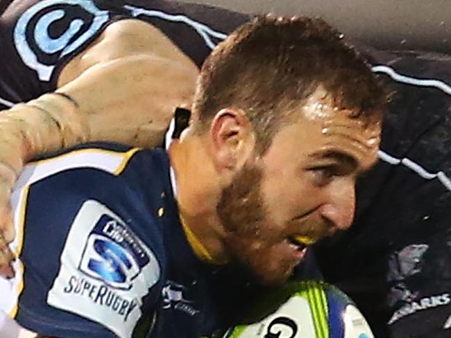 CANBERRA, AUSTRALIA - MAY 10: Nic White of the Brumbies is tackled during the round 13 Super Rugby match between the Brumbies and the Sharks at Canberra Stadium on May 10, 2014 in Canberra, Australia. (Photo by Mark Nolan/Getty Images)