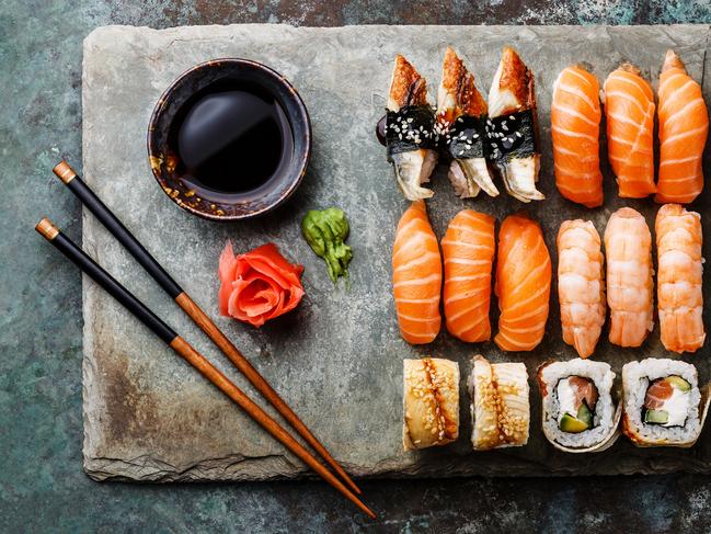 Sushi rolls set served on gray stone slate on metal background; ISTOCK