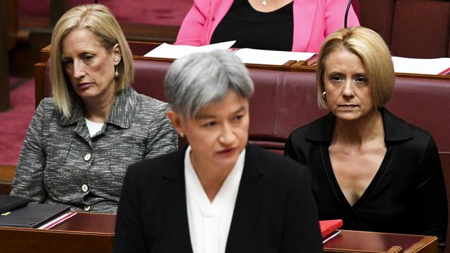 Labor senators Katy Gallagher, left, and Kristina Keneally, right, flank Penny Wong as she pays tribute to Kimberley Kitching in the Senate on Monday. Picture: AAP