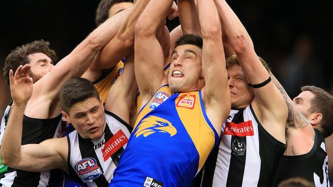 Elliot Yeo flies for a mark in a pack of Magpies. Picture: Mark Stewart