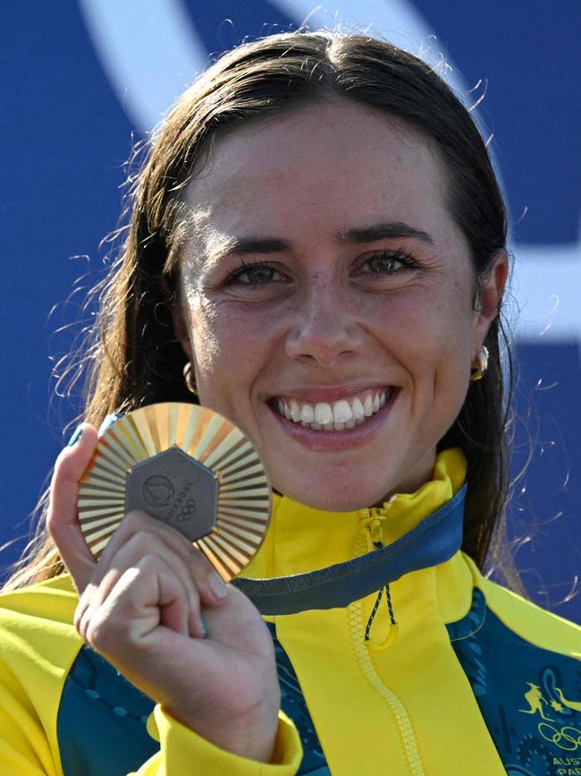 Noemie Fox a celebrates with her gold medal for the women's kayak cross. Picture: AFP