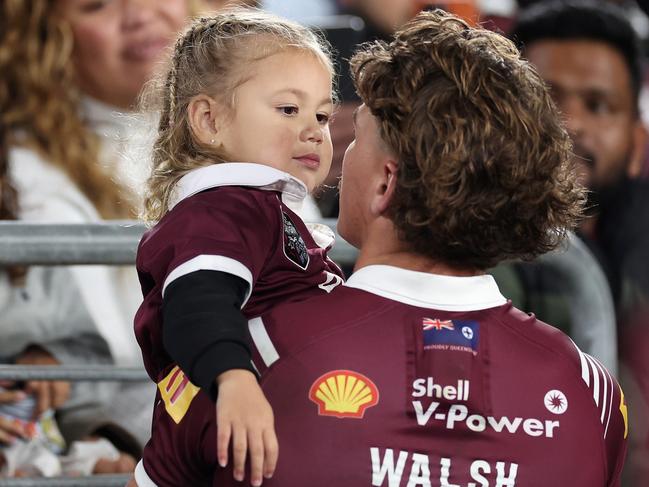 Reece Walsh with daughter Leila on the sidelines. Picture: Cameron Spencer/Getty Images