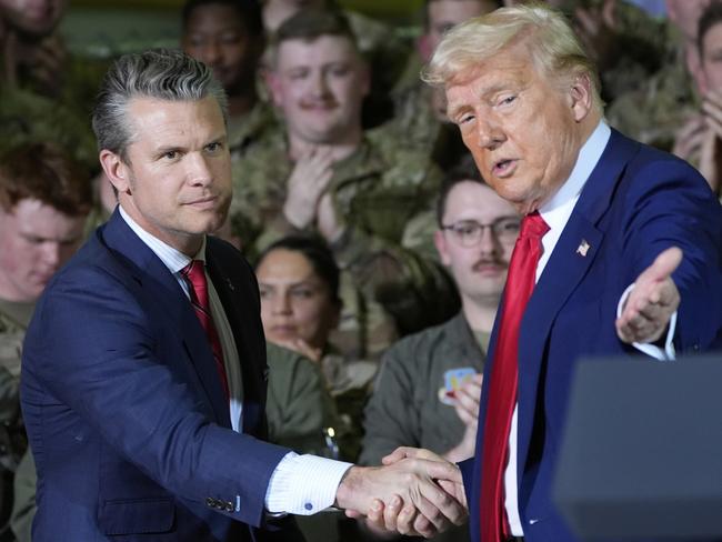 President Donald Trump shakes hands with Defense Secretary Pete Hegseth as he speaks to members of the Michigan National Guard. Picture: AP Photo/Alex Brandon