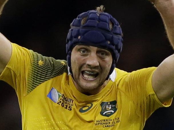 Australia's Dean Mumm charges towards a kick from Fiji's Ben Volavola during the Rugby World Cup Pool A match between Australia and Fiji at the Millennium Stadium, Cardiff, Wednesday, Sept. 23, 2015. (AP Photo/Matt Dunham)