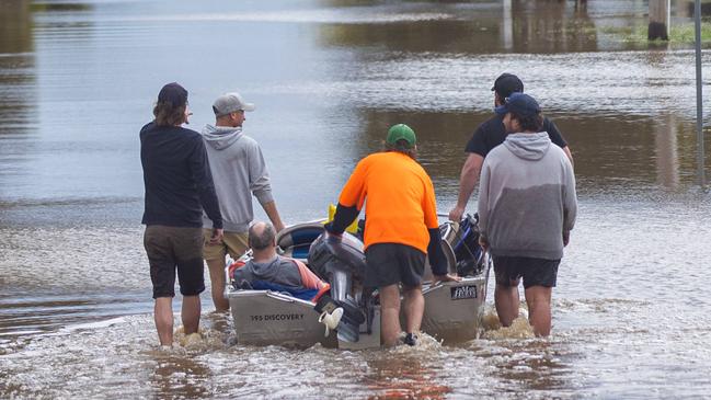 Kate Pianta and her husband Ray and dog Grace had to be rescued after the SES said they would not come back to get her if she didnÃt leave her dog. The dog is a rescue who is quite nervous. Locals helped rescue her with two boats , locals include Reece Causer  0497133287 (dark grey jumper) and Rick Windridge (in grey jumper) 0498726514Saturday 15th Rochester township floods from the Campaspe River as it rises through the streets. Picture: Jason Edwards