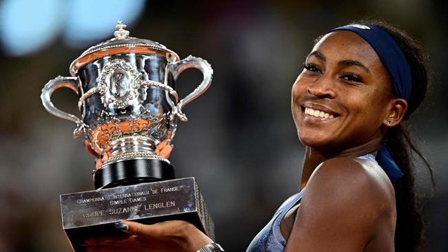 US Coco Gauff holds the trophy after winning the French Open final. (Photo by JULIEN DE ROSA / AFP)