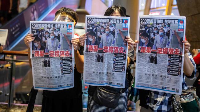 Hong Kongers hold copies of Apple Daily during a press freedom protest inside a shopping mall in August 11. AFP