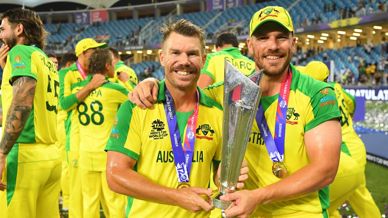 David Warner and Aaron Finch of Australia poses with the ICC Men's T20 World Cup Trophy. Photo by Gareth Copley-ICC/ICC via Getty Images