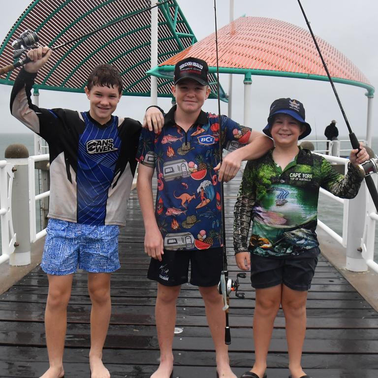 Wet weather in Townsville. Aiiden, Tully and Jaxon try their lick on the Strand. Picture: Evan Morgan