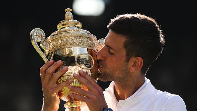 Djokovic kisses his trophy after defeating Australia's Nick Kyrgios during the 2022 Wimbledon men's singles final. Picture: Adrian Dennis/AFP