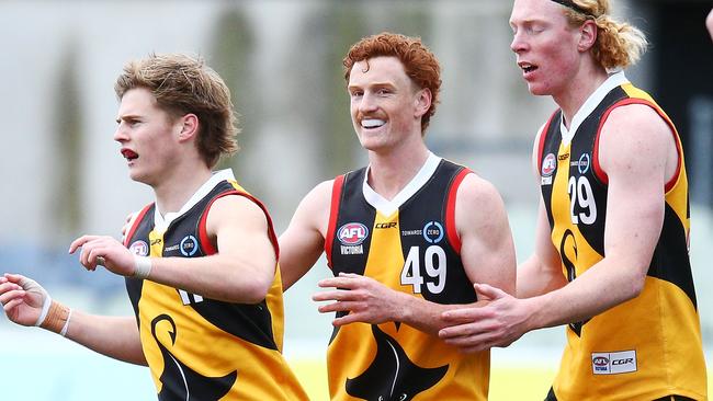 Ned Cahill (right) after kicking a goal for the Stingrays.