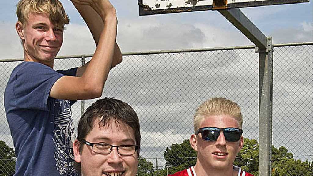 SHOOTING HOOPS: Toowoomba Bushrangers coach Luke McErvale (front) joins Clifford Park Special School senior students Matthew Berry (left) and Dylan Barber in a game of basketball. Picture: Nev Madsen