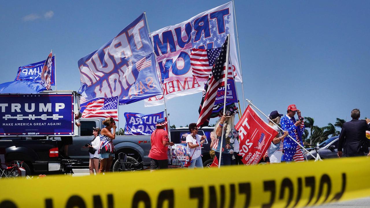 Supporters of US former President Donald Trump gather near his Mar-A-Lago home in Palm Beach, Florid on Monday. Mr Trump is expected to be arraigned in Miami on Tuesday. Picture: AFP