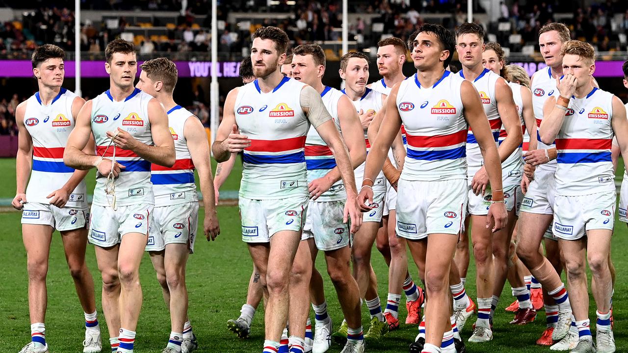 Josh Dunkley and the Bulldogs walk off the Gabba after their loss to Brisbane last year. (Photo by Bradley Kanaris/Getty Images)