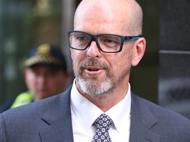 Former Victoria Police Chief Commissioner Simon Overland leaves the Royal Commission into the Management of Police Informants at the Fair Work Commission in Melbourne, Wednesday, December 18, 2019. (AAP Image/David Crosling) NO ARCHIVING