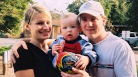 Riley, Ben and Claudine with a Crows football when Riley was a baby. Picture: Supplied by family