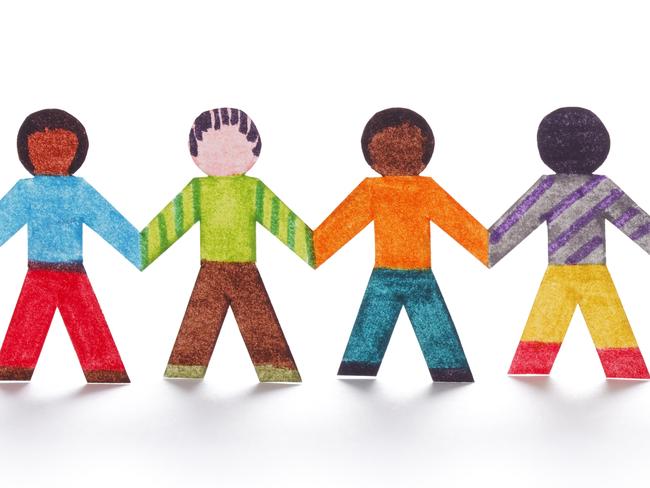 Colorful paper people standing in a line holding hands.paper people diversity istock