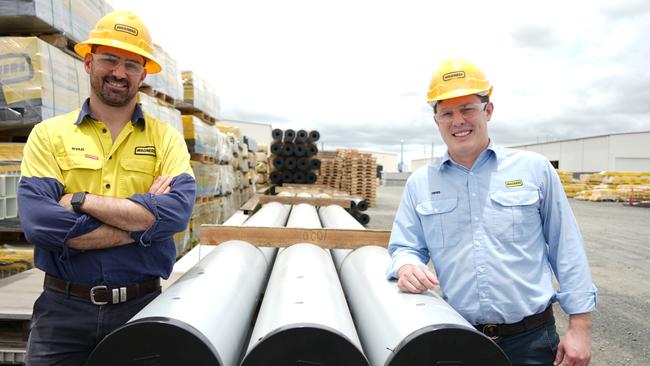 Showcasing the length of Wagners' new power poles, made from the company's composite-fibre technology, are CFT Australia and New Zealand general manager Ryan Leeson and president of North American operations Denis Wagner Jr.