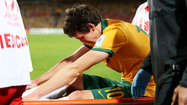 A visibly upset Robbie Kruse is stretchered from the field.