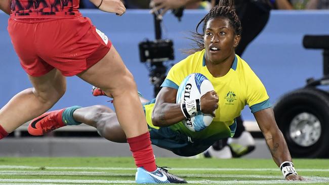 Australia's Ellia Green scores a try against Wales in their women's rugby sevens match at Robina Stadium. Picture: AFP