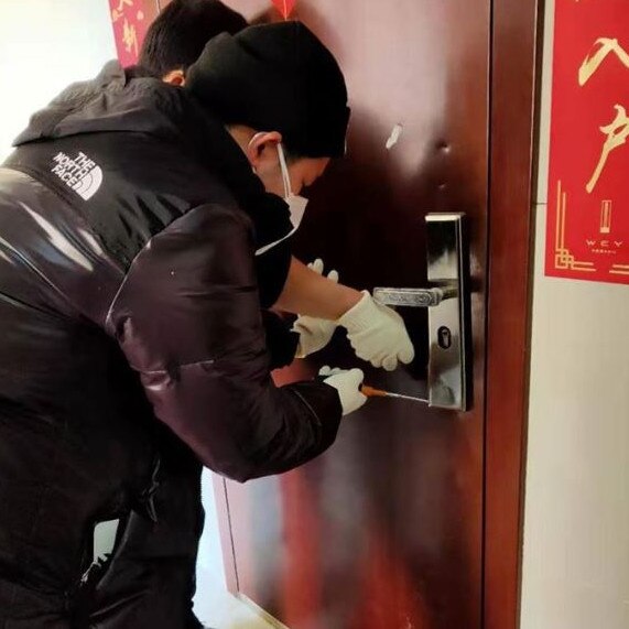Rescuers gain access to a property to assist pets inside. Picture: Wuhan Pet Life Online