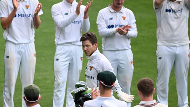 Tim Paine is acknowledged by players as he leaves the field during the Sheffield Shield match between Tasmania and Queensland at Blundstone Arena, on March 17. Photo by Steve Bell/Getty Images.