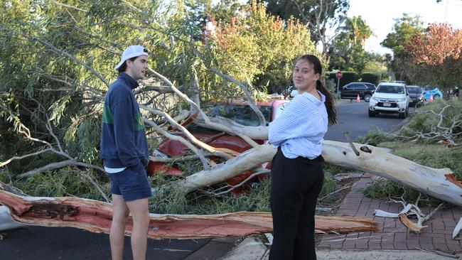 Bella Bernardi and partner Jack Carruthers, looking at Bella’s car crushed by a huge lemon-scented gum branch. Picture Dean Martin