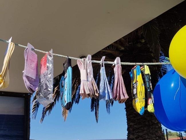 Socks hanging at Warrnambool Civic Green on a washing line to be donated for the Helping Hand from Warrnambool to Ukraine fundraiser.