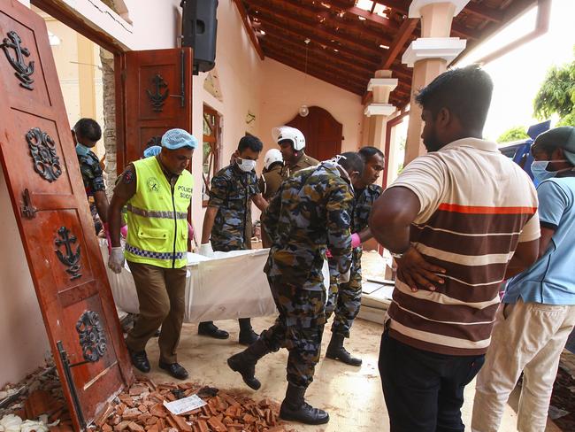 Sri Lankans carry a body at St. Sebastian's Church in Negombo, north of Colombo. Picture: AP Photo/Chamila Karunarathne