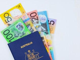 Australian currency dollars cash banknotes an Australian passport with white background