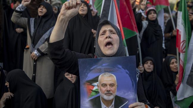 Protestors hold photos of Ismail Haniyeh, a senior Hamas leader who was assassinated in Iran on Wednesday, at a square in Tehran. Picture: Majid Saeedi/Getty Images