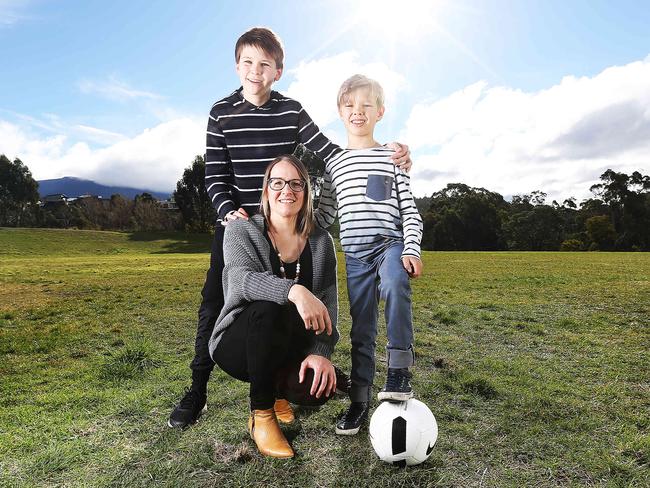 Kingston mum Alison Roebuck with sons Oscar, 12, and Milo, 8, at the site of the planned playground in Kingston. Picture: ZAK SIMMONDS