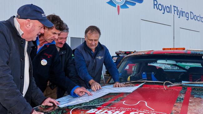 Editor-at -large Matthew Benns, driver James Calvert-Jones,cartoonist Warren Brown and co-driver Harley Kruse planning their route for the The Bush Summit Rally. Picture: wrightphoto1@mac.com