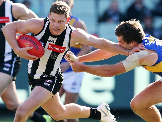 AFL Round 17. 15/07/2018. Collingwood v West Coast at the MCG.  Collingwood's Taylor Adams pushes away the tackle of West Coast's Andrew Gaff 2nd qtr    . Pic: Michael Klein