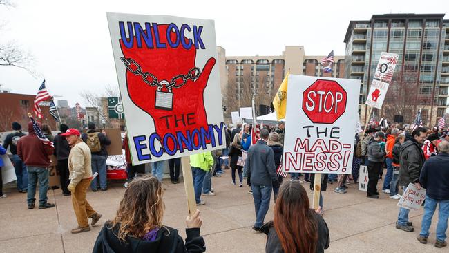 People protest against the coronavirus shutdown in front of the State Capitol in Madison, Wisconsin, on April 24. Gyms, hair salons and tattoo parlours have a green light to reopen in the US state of Georgia.