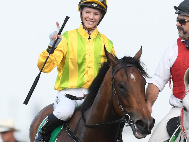 Jockey Stephanie Thornton gestures after riding Sugar Boom to victory in race 7, the Mode Plate, during The Metro Races at Doomben Racecourse in Brisbane, Saturday, November 30, 2019. (AAP Image/Albert Perez) NO ARCHIVING, EDITORIAL USE ONLY