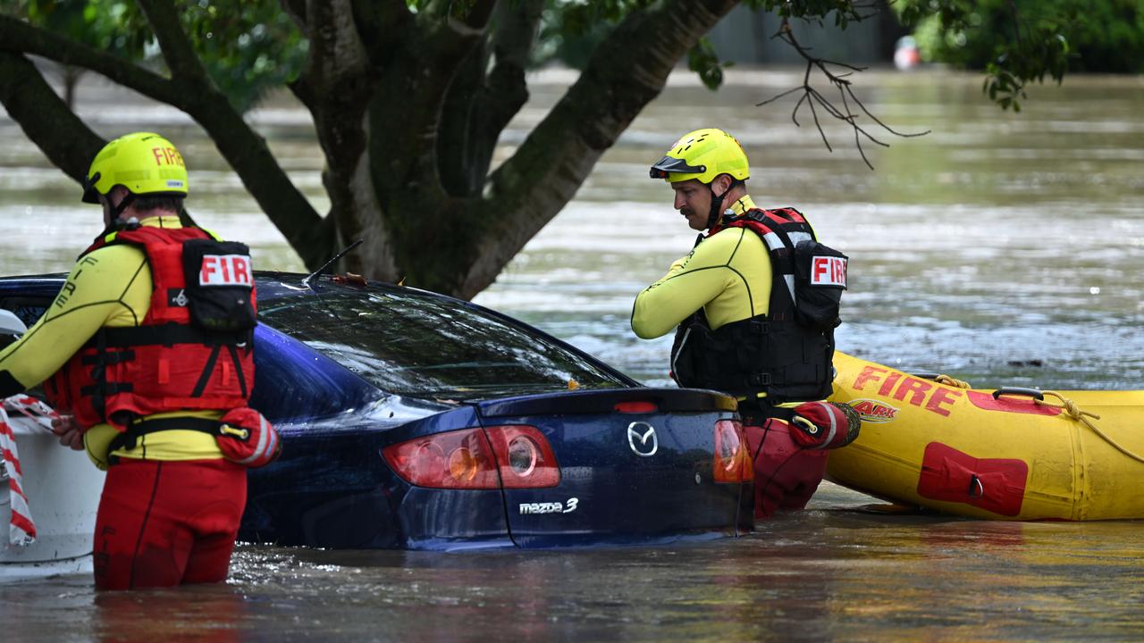 1/122024: Flash flooding in Hanlon Park, rapidly flooded around 10 cars, as police and fire and rescue check the cars are empty, Stones Corner, Brisbane. pic: Lyndon Mechielsen/Courier Mail